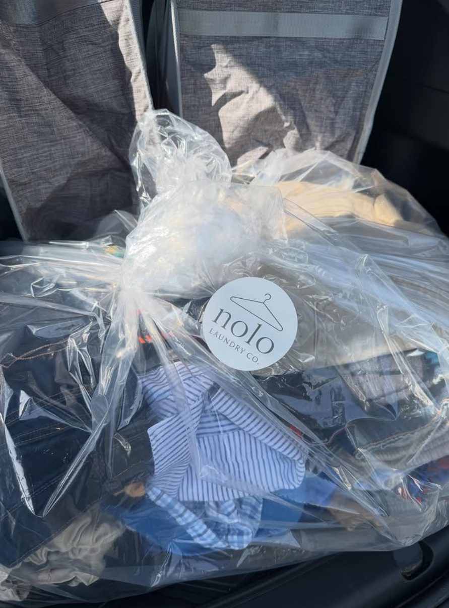 A finished order sealed with a Nolo Laundry Co. sticker